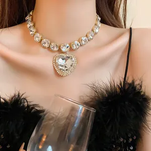 Close-up of heavy industry heart diamond choker on model with luxury feather top