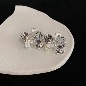 Detailed macro view showing the unique crumpled texture of these silver floral stud earrings.