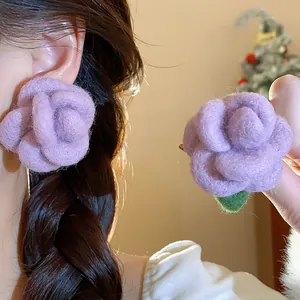 Detailed view of handmade purple flocked rose flower stud earrings with silver needles