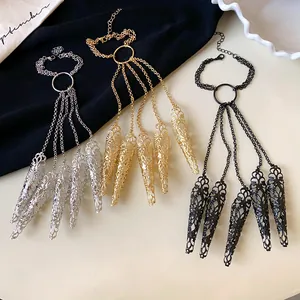 Detail showing hollow floral pattern nail cover bracelets in silver, gold, and black