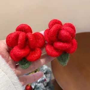 Detailed close-up view of vibrant red flocked flower stud earrings with a soft texture