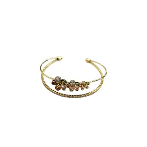 Elegant double-layered gold open cuff bracelet with shiny multicolored zircon flowers