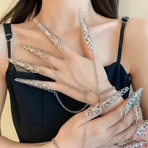 Detailed view of silver hollowed-out pattern nail sleeve rings with chain harness
