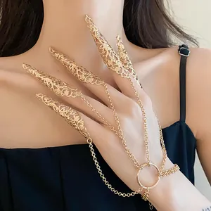 Intricate gold filigree finger armor claw rings connected by chains to a bracelet