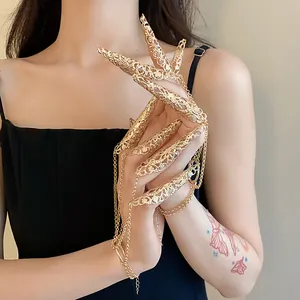 Detailed view of exquisite hollow pattern nail sleeve bracelet with gold tassels