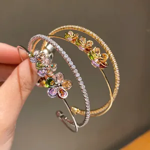 Close-up detail of double-layer zircon flower bangle in gold and silver finish