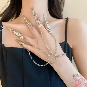 Detailed view of silver hollow filigree nail claw rings connected by elegant hand chain