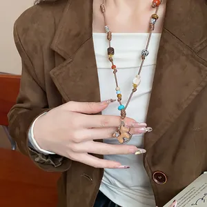 Detailed view of a handmade woven rocking horse sweater chain necklace for women