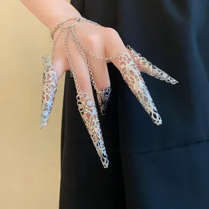 Intricate silver hollow pattern nail set with connected finger chains and bracelet