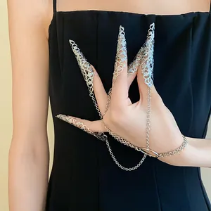Elegant silver filigree hollow nail guards connected by delicate tassel chains to a bracelet