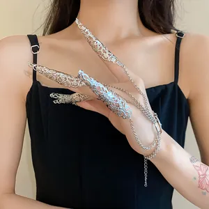 Close-up of silver hollow floral nail cover rings connected with delicate tassel chain