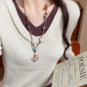 Exquisite hand-woven rocking horse pendant necklace on a braided leather cord for women.