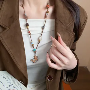 Close-up of hand-woven leather cord necklace with a rocking horse pendant for women