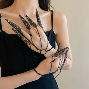 Close-up of gothic black hollow-out floral pattern nail cover ring bracelet