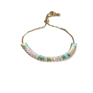 Elegant gold plated bracelet with multi-colored baguette-cut cubic zirconia stones.
