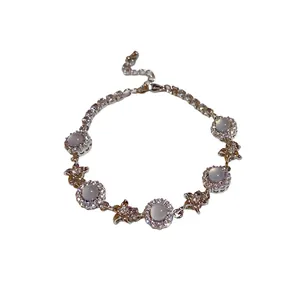 Elegant silver-toned flower bracelet featuring white chalcedony and sparkling zircons