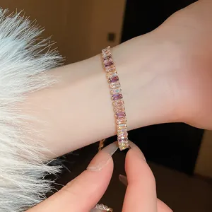 Close-up view of an elegant gold-plated bracelet featuring multi-color rectangular zircons