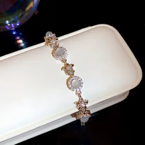 Close-up of silver chalcedony flower bracelet with sparkling zircons on jewelry box