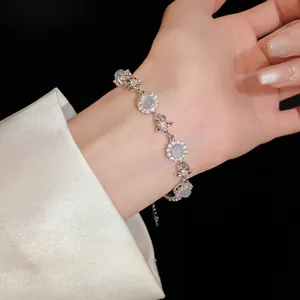 Elegant silver-toned chalcedony and zircon flower bracelet shown on wrist.