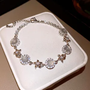 Elegant silver-toned bracelet featuring sparkling zircon flowers and milky chalcedony stones
