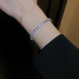 Close-up of a sparkling gold-plated zircon tennis bracelet worn elegantly on the wrist.