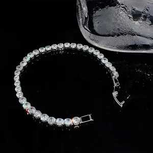 Detailed close-up of a sparkling cubic zirconia tennis bracelet on a black reflective surface