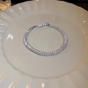 Detailed view of shimmering baguette-cut zircon bracelet on an elegant white ceramic plate