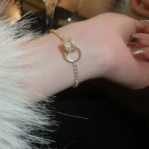Close-up shot of elegant gold-plated zirconia bracelet featuring geometric ring design