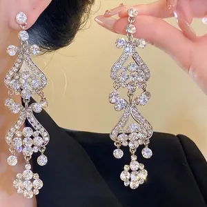 Luxury silver-tone tassel earrings featuring intricate rhinestone drops for an elegant look.