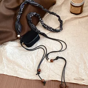 Detailed view of vintage mini pouch with paisley scarf waist chain and wooden beads