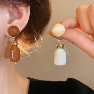Vintage resin drop earrings in brown and white marble pattern with gold knot detail