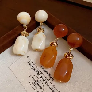 Vintage Maillard style irregular resin earrings in retro amber and cream marble colors.
