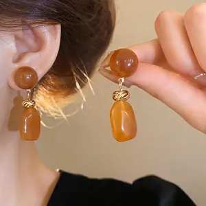 Retro Maillard amber resin earrings with irregular drop design and silver needle
