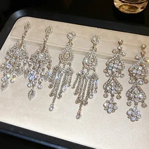 Close-up of sparkling rhinestone tassel earrings in teardrop and diamond shapes