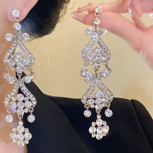 Close-up detail of luxury silver needle chandelier earrings with sparkling rhinestones