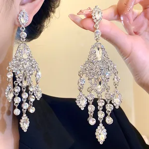 Close-up of elegant rhinestone chandelier earrings with teardrop and marquise crystals
