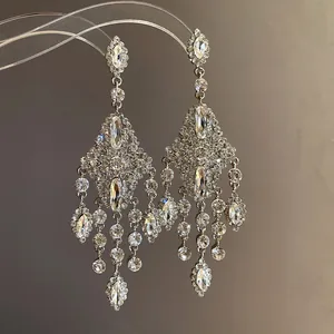 Detailed view of silver tassel chandelier earrings with sparkling marquise crystals.
