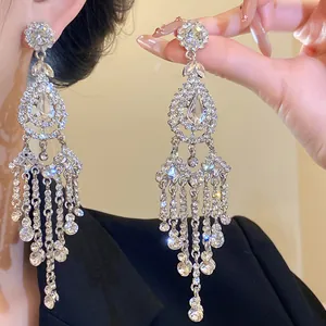 Detailed view of luxury silver needle tassel earrings with sparkling rhinestones