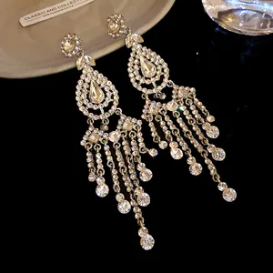 Detail view of luxury rhinestone water-drop chandelier earrings with elegant tassel design