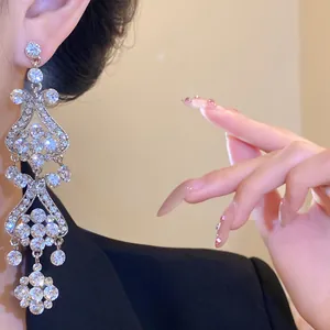 Close-up of luxury silver needle chandelier earrings with sparkling crystal tassels