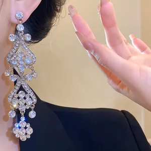 Close-up of sparkling silver rhinestone tassel earrings worn for a luxurious look