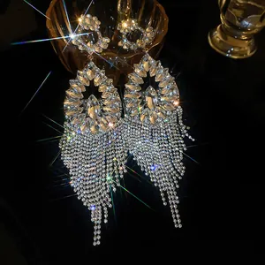 Macro detail showing luxury palace style silver zircon flower tassel earrings with sparkle.
