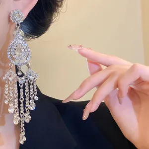 Close-up of sparkling rhinestone tassel earrings with waterdrop and diamond accents