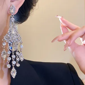 Close-up of elegant silver-toned chandelier earrings with shimmering rhinestones
