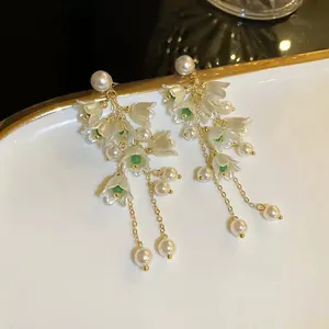 Vintage French style lily of the valley flower earrings with pearl tassels close-up.