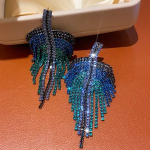 Close-up of vintage-style blue rhinestone fringe earrings with leaf design