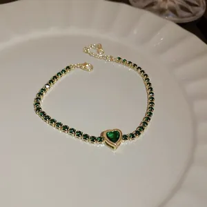 Elegant gold-plated tennis bracelet featuring green heart zircon and adjustable chain closure