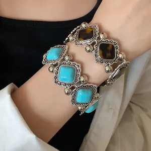 Close-up of bohemian vintage elastic bracelets with turquoise and tortoise acrylic