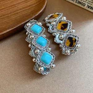 Close-up of bohemian elastic bracelets with turquoise and tortoiseshell acrylic stones