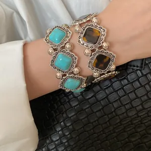 Detail of bohemian retro acrylic bracelets with turquoise and tortoiseshell patterns